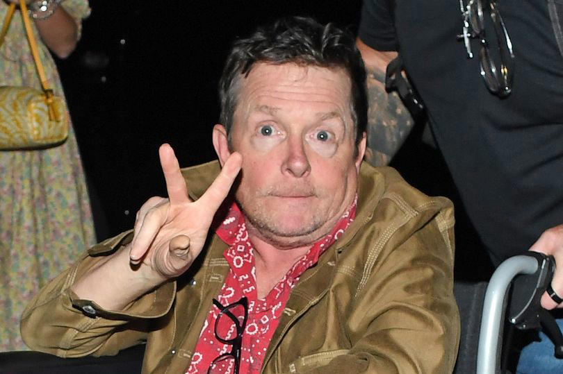 michael j fox flashes a peace sign from wheelchair in rare outing amid parkinson's battle
