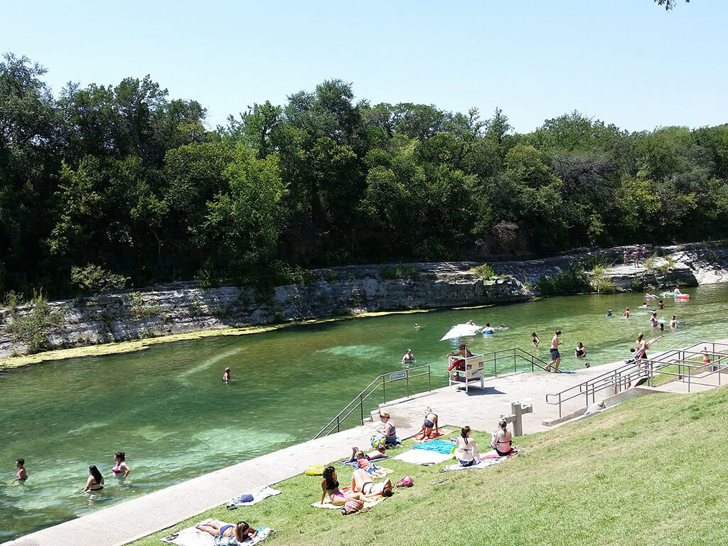<p>In the heart of Austin’s Zilker Park, you’ll find a unique oasis that’s perfect for a refreshing dip year-round. While it’s not your typical piping hot spring, this beloved spot maintains a comfortable 70 degrees, making it a favorite gathering place for locals and visitors, no matter the season. In fact, it’s not uncommon to see folks enjoying a morning swim even on crisp fall or winter days. With depths ranging from zero to 18 feet, there’s plenty of space to splash around, and for the more adventurous souls, there’s even a diving board on site. </p>