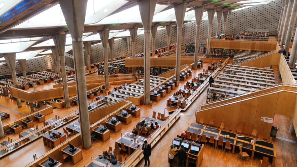 <p>The New Library of Alexandria, or Bibliotheca Alexandrina, is the rebuilt version of the original Library of Alexandria. The old library was home to many precious manuscripts from Egypt, Persia, India, and Assyria. However, in 48 BC, part of the library was <a href="https://ehistory.osu.edu/articles/burning-library-alexandria">burned down</a> as a consequence of Julius Caesar’s battle with Pompeii.</p><p>The building now houses modern and classical literature and serves as a cultural and education center with a museum and planetarium. It has a tilted circular structure with skylight windows on the roof and granite walls featuring hand-carved symbols from different languages.</p>