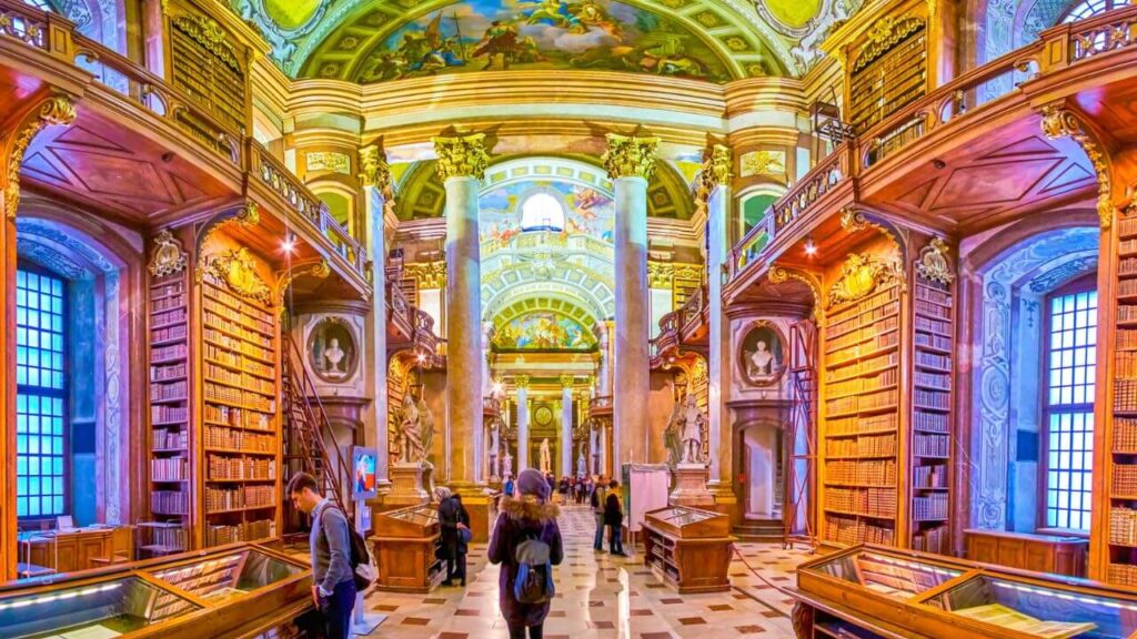 <p>Another library with frescoed ceilings is the National Library of Austria. Its Baroque architecture is a remnant of the building’s deep history. The design, artworks, displays, and even the bookcases seem to reference classic architectural style.</p><p>The National Library of Austria currently holds over 200,000 collections, including Martin Luther’s manuscripts. Other important pieces and accents in the library are the Venetian Baroque Globes and a “becoming of God” painting of Emperor Charles VI spread across a dome ceiling.</p>