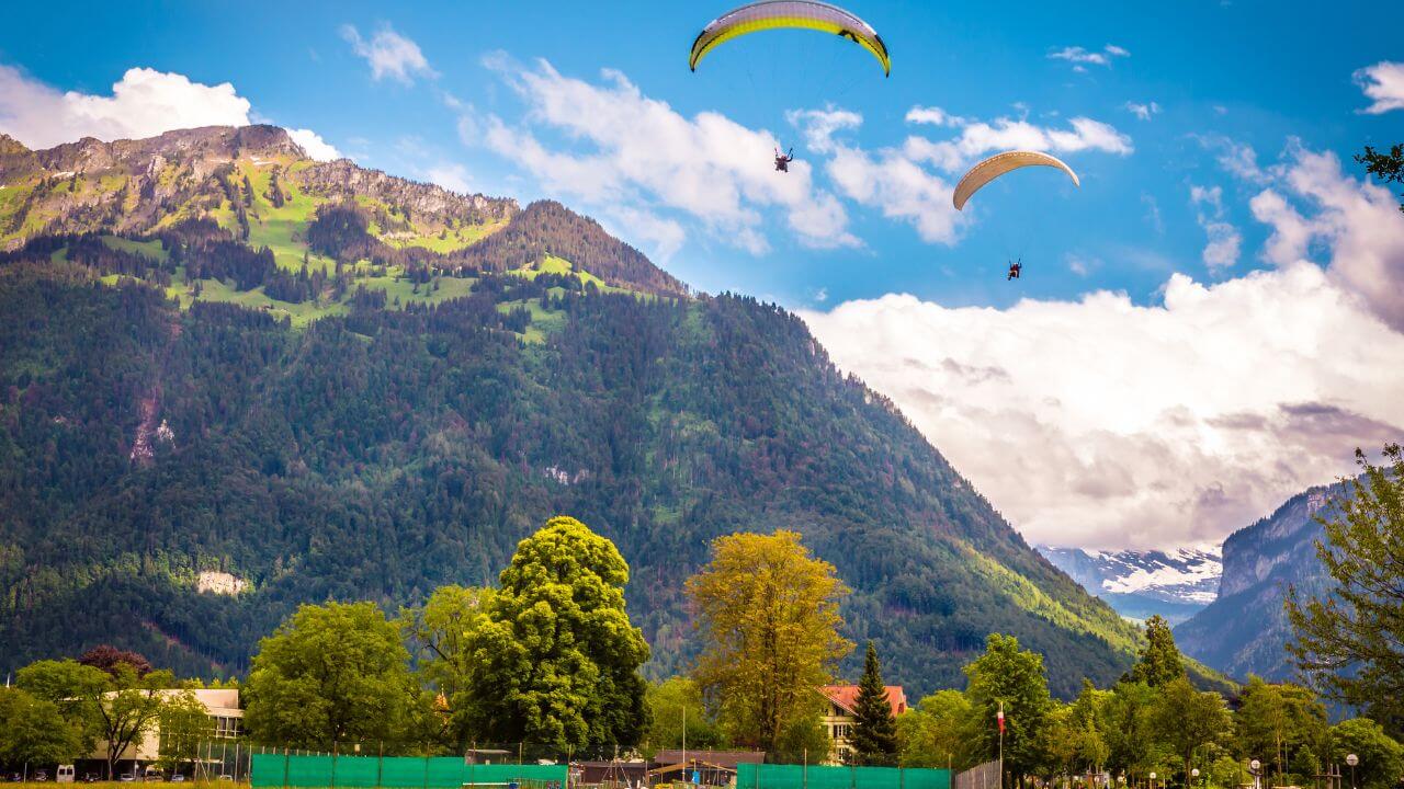 <p><span>During summer, Interlaken abounds in outdoor activities and points of interest. Here are some of the best things you can do during summer in Interlaken:</span></p> <ol>   <li><span>Paragliding: Take a tandem paraglide flight and sail through the air with unobstructed views of Interlaken and its surrounding mountains.</span></li>   <li><span>Lake trip: A relaxing boat ride across Lake Thun or Lake Brienz lets you appreciate the scenic beauty of surrounding landscapes and crystal-clear waters.</span></li>   <li><span>Walking route: Explore the picturesque walking paths around Interlaken and absorb yourself into the awe-inspiring beauty of the Swiss Alps.</span></li>   <li><span>Summer activities: Experience such adventures as canyoning, white water rafting, mountain biking, etc., thus getting involved in an exciting outdoor activity.</span></li>  </ol> <p><span>Interlaken offers a beautiful backdrop for outdoor adventures in summer. There is something to suit everyone, whether you crave adrenaline or just want to take a walk in nature.</span></p>