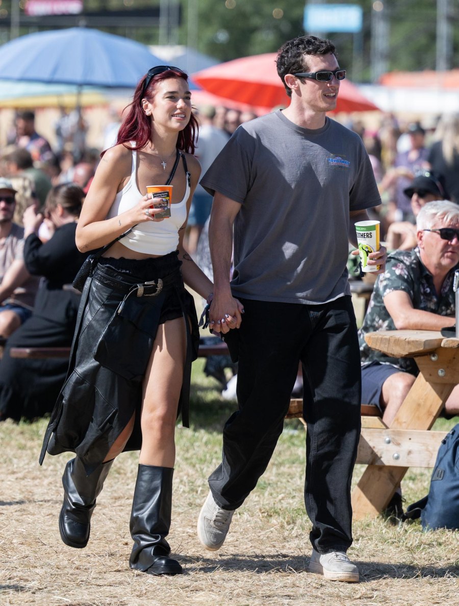 <p>Dua Lipa’s burgundy hair paired great with her white tank top and black bottoms, black boots and sunglasses. She also wore a cross necklace and a black crossbody bag. Callum rocked similar neutrals, wearing dark jeans, a gray T-shirt and gray sneakers.</p>