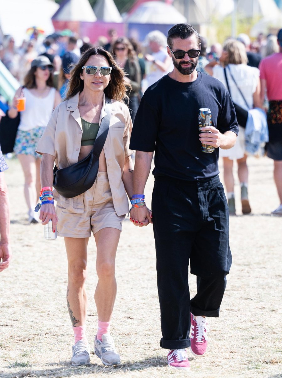 <p>Sporty Spice lived up to her name in a matching tan short and button-up top that she wore open displaying her army green bralette underneath and white sunglasses. On her feet, she wore gray trainers with pink socks.</p>