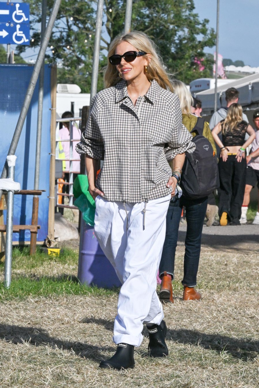 <p>The actress blended right in with a loose tan and black checkered button up paired with baggy white pants, black boots and black sunglasses.</p>