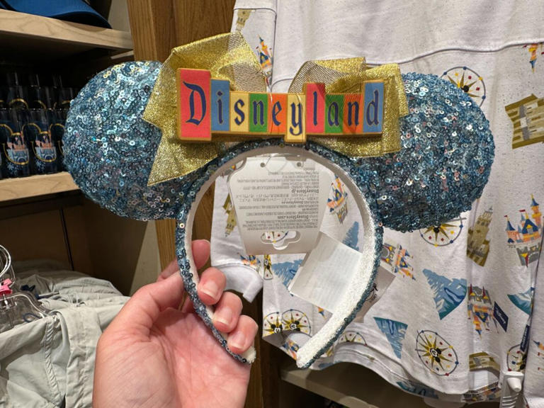 A new retro Disneyland marquee ear headband is now available at Disneyland Resort. Retro Disneyland Marquee Ear Headband – $34.99 We found this new retro Disneyland marquee ear headband in World of Disney in Downtown Disney District. The ears and exterior of the headband are completely covered with blue sequins. The interior of the headband ... Read more