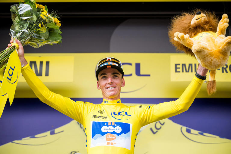 French Romain Bardet of Team DSM-Firmenich PostNL wearing the yellow jersey of leader in the points ranking celebrates on the podium after stage 1 of the 2024 Tour de France from Florence, Italy to Rimini, Italy. (Photo by JASPER JACOBS/BELGA MAG/AFP via Getty Images)
