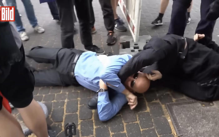 german politician bites protester during scuffle