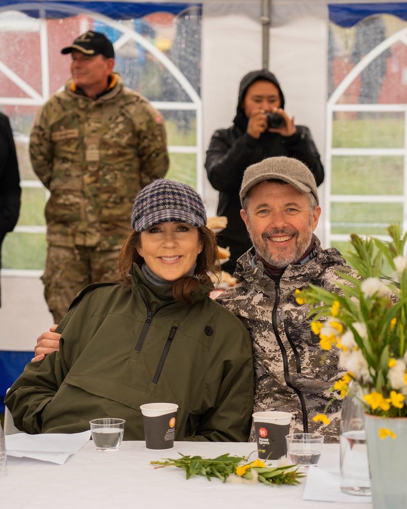 <p>The couple braved the rainy weather to join residents for a special coffee morning in Qassiarsuk. Mary snuggled into her husband as a beaming Frederik put his arms around his wife. The couple matched in waterproof outerwear and baseball caps. </p>