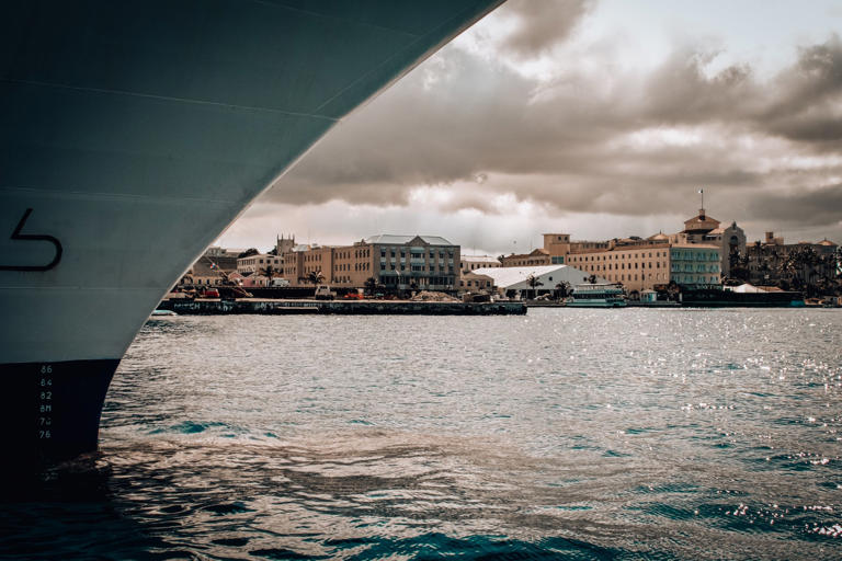 Scenic View Of Sea By City Against Sky