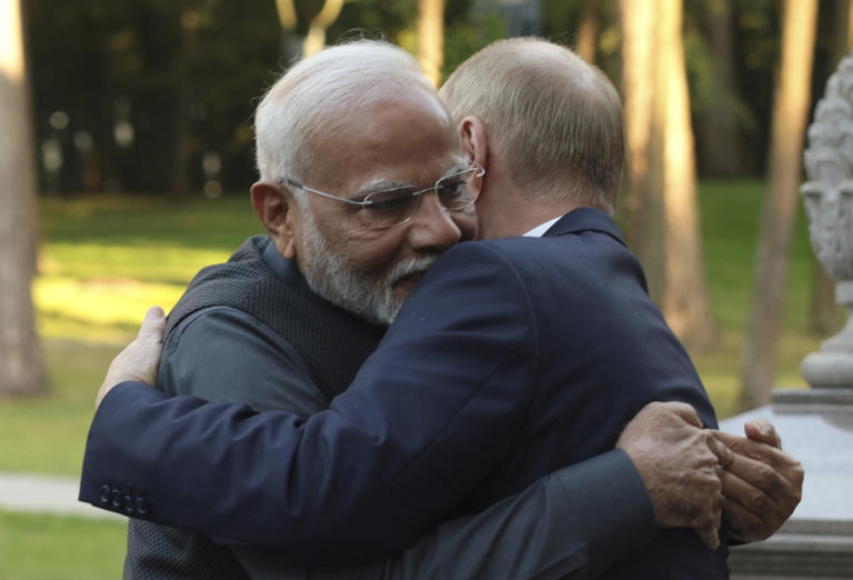 Indian Prime Minister Modi, left, and Putin embrace.
