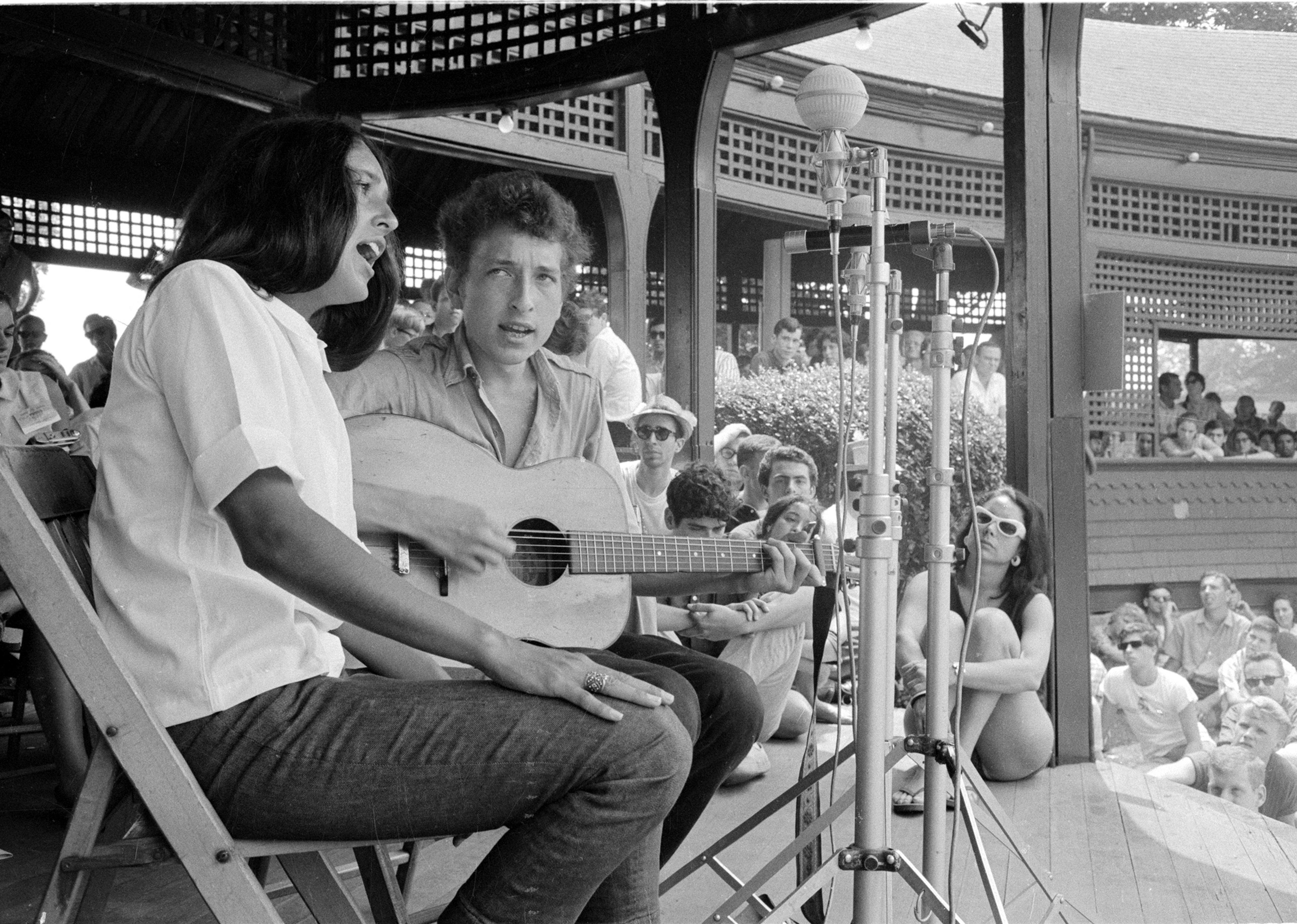 <p>The 1963 Newport Folk Festival arrived when the genre of folk was politically charged and more popular than ever before. Playing the <a href="https://www.bobdylan-comewritersandcritics.com/pages/programmes/dylan-newport-festival-1963.htm">festival for the first time</a>, a young Bob Dylan performed anti-war songs and duly captured the local zeitgeist. Two years later, he shed his spokesman persona at the same festival by <a href="https://www.history.com/this-day-in-history/dylan-goes-electric-at-the-newport-folk-festival">plugging in his electric guitar</a>.</p>