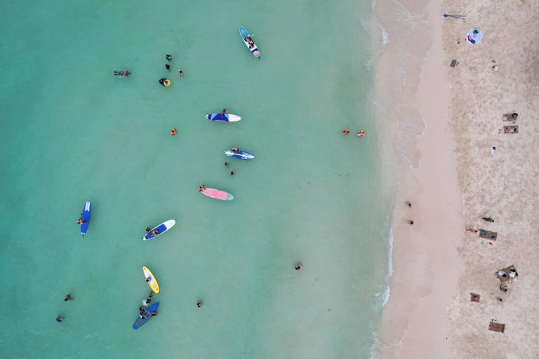 People relax along White Beach amid the coranavirus disease (COVID-19) outbreak, in Boracay Island, Aklan province, Philippines, December 1, 2021. Picture taken December 1, 2021. Picture taken with drone. REUTERS/Eloisa Lopez/File Photo