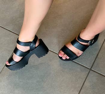 reviewer wearing the sandals in black