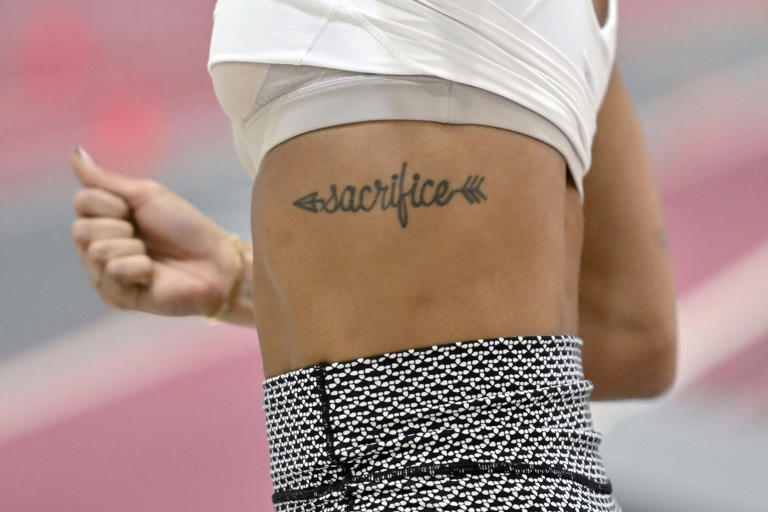 FILE - Olympic long jumper Tara Davis-Woodhall makes a practice jump at the Randal Tyson Track Center, Thursday Jan. 18, 2024, in Fayetteville, Ark. It's one thing to plan for the Olympics — completely different to get there.(AP Photo/Michael Woods, File)