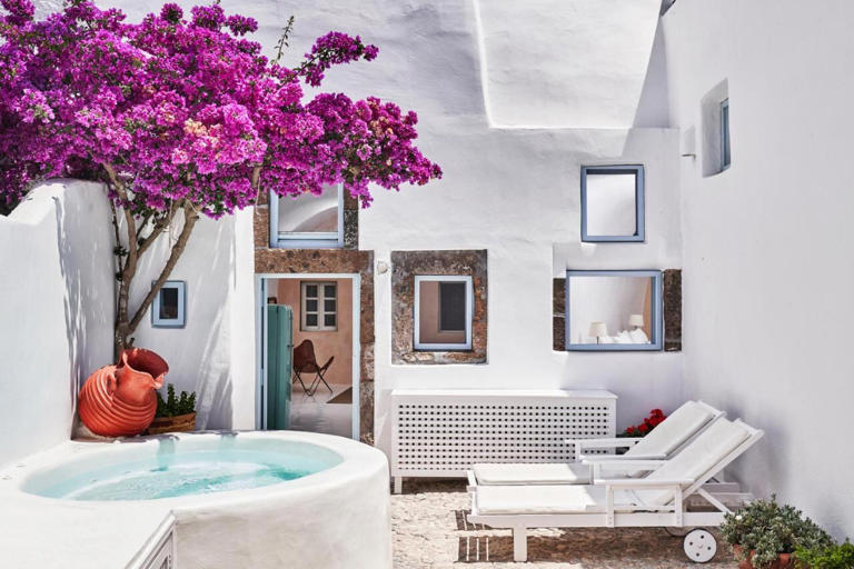 This Plum Guide villa features a charming cobbled courtyard garden adorned with tumbling bougainvillaea and olive trees, offering an outdoor heated Jacuzzi, perfect for a relaxing stay amidst the Cycladic vibes. Photo / Supplied