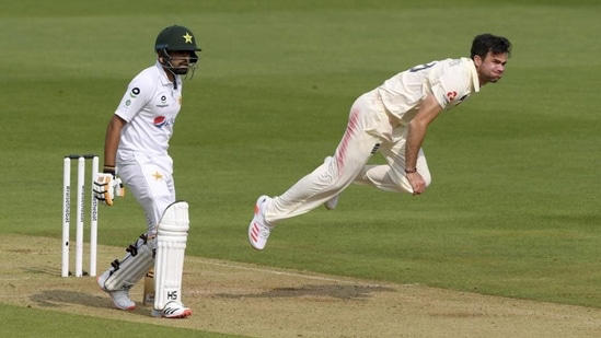 England's James Anderson, right, bowls a delivery past Pakistan's Babar Azam