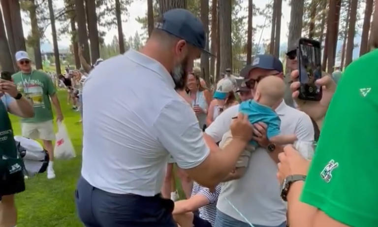 Jason Kelce signs a fan's BABY at celebrity golf tournament