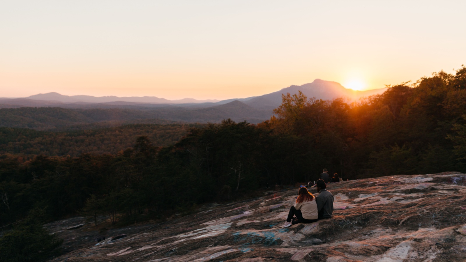image credit: MILA PARH/Shutterstock <p>Perched on the edge of Cheaha Mountain, Bald Rock offers panoramic views of the Talladega National Forest. The boardwalk to the overlook makes it accessible to all visitors, providing a stunning vantage point to watch the sunset. The rock’s sheer expanse and the sweeping landscape below make it a breathtaking spot.</p>