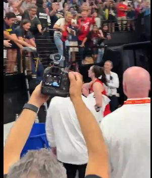 Caitlin Clark tosses her sneakers to a young fan after the Fever’s win on Sunday. Fever/X