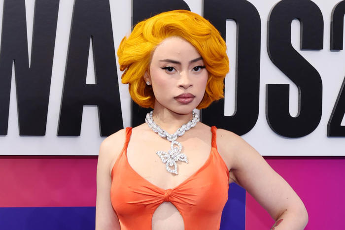 ice spice is a vixen in vintage versace gown that dips below her belly button at 2024 bet awards
