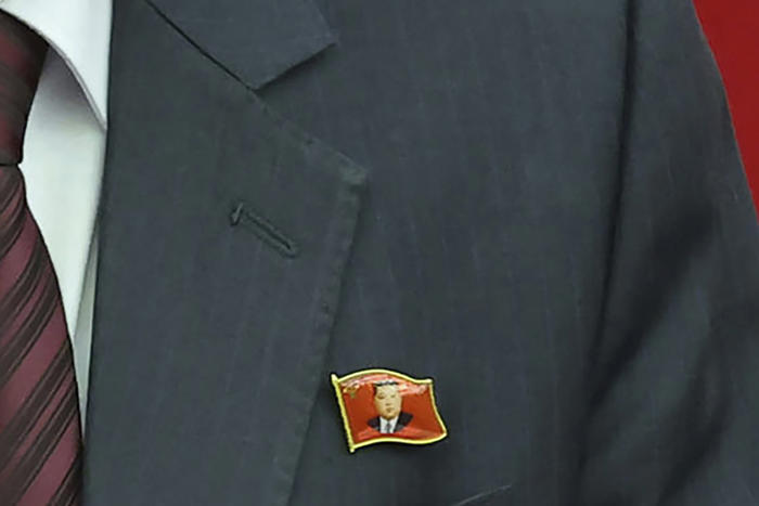 north koreans seen wearing kim jong un pins as his personality cult grows