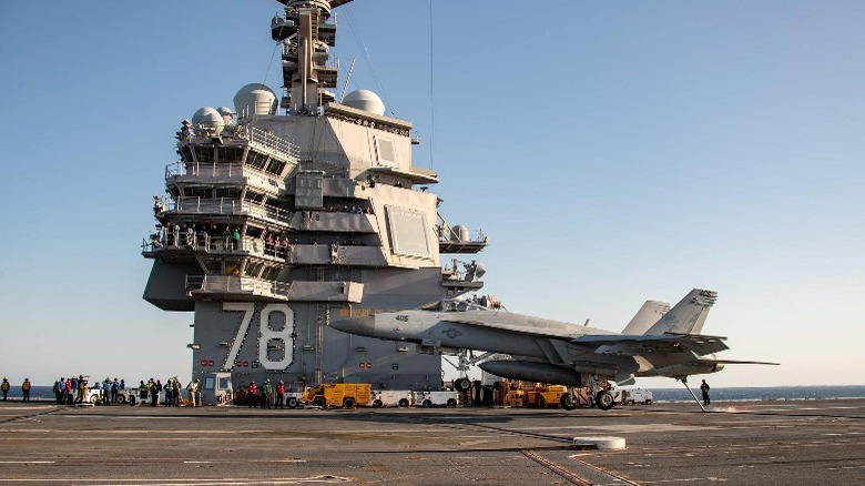 which aircraft carrier is the world's largest, and how many planes can it carry?