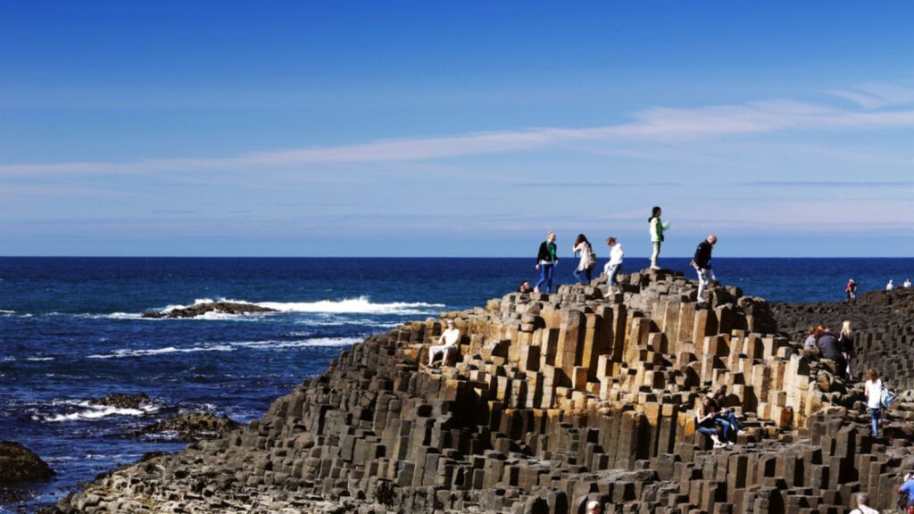 <p>This geological wonder, which is thought to have been formed millions of years ago by volcanic activity, is a mesmerizing sight. Thousands of hexagonal basalt columns rise from the sea, creating a natural staircase that seems to lead to another world.</p><p>Explore the rugged coastline, hike the trails that wind through the dramatic landscape, and marvel at the intricate patterns of the basalt columns. The Giant’s Causeway is a testament to the Earth’s raw power and creativity, a place where geology and mythology intertwine.</p>