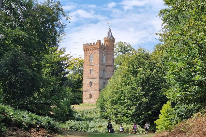 romantic garden with gothic tower and ruined abbey that looks straight out of a fairytale