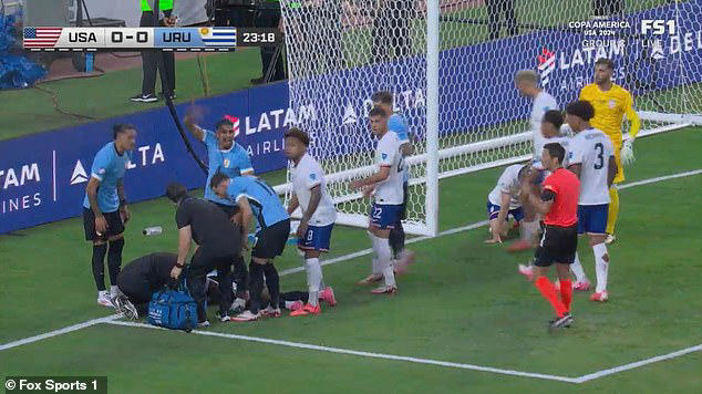 Uruguay star Maximiliano Araujo is stretchered off with his neck in a ...