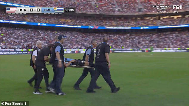 Uruguay star Maximiliano Araujo is stretchered off with his neck in a ...