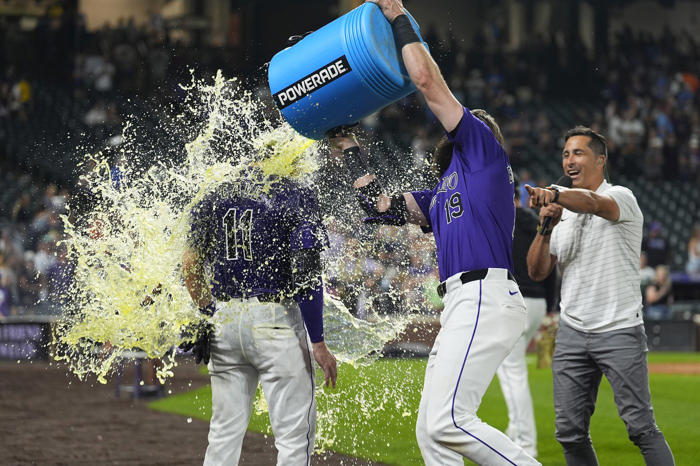 jake cave hits an rbi single in the 10th inning to lift the rockies over the brewers 8-7