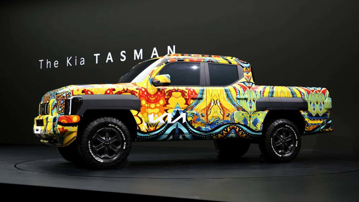 kia brings its new truck with a funky wrap to a car show
