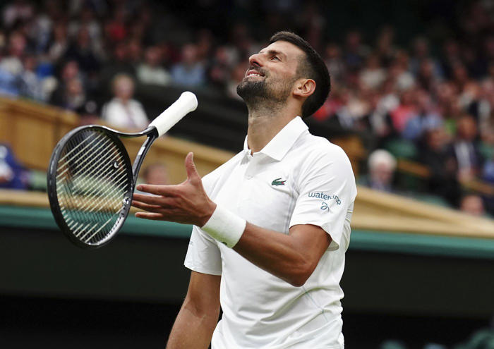 novak djokovic wins his first match at wimbledon with a sleeve on his surgically repaired knee