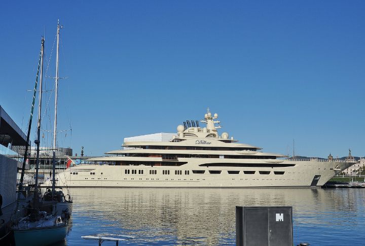 <p>Imagine enjoying the ocean view when a 512-foot yacht, the length of two football fields, appears. This stunning vessel, named after the owner’s mother, Dilbar Usmanova, features one of the largest indoor pools (82 feet) ever seen on a yacht. With two helipads, a lavish interior, and top-notch amenities designed by Winch Design, its high price tag is justified. The yacht, owned by a company held in a trust settled by Russian oligarch Alisher Usmanov, who amassed his wealth in metal and mining, was seized by German authorities in 2022 as part of sanctions following the invasion of Ukraine. As of now, it remains in German custody.</p>