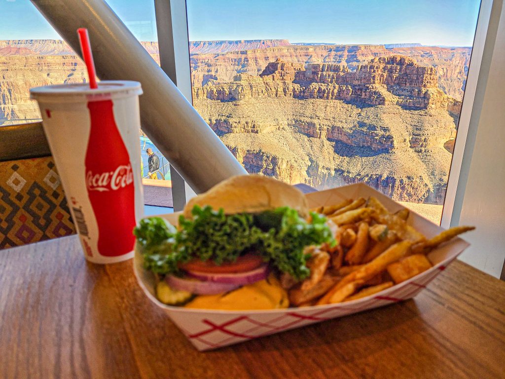 <p>The Skyview Restaurant has a simple short order lunch menu and a limited alcoholic drink selection. The cheeseburgers are legitimately good, but you really aren’t here for the food. True it’s the best food around and an important logistic stop on any Grand Canyon West tour, but the name says it all – Skyview.</p> <p>If you can, you want to make sure that you can get a window seat. There are a couple of ways to do this. We recommend getting to Grand Canyon West early to beat the heat and the crowds and eat at Skyview for an early brunch. Alternatively, you can put your name on the reservation list, specify a window seat, and wait your turn. If you’re doing this, consider checking in when you arrive at Eagle Point and doing some exploring until it’s close to when your name will be called.</p>
