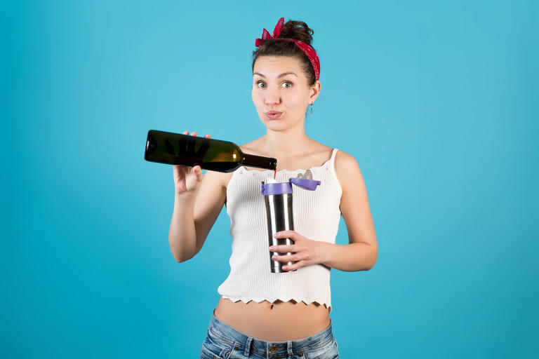 A young woman hides wine in a thermos under the guise of tea