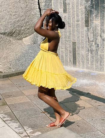 reviewer wearing yellow dress