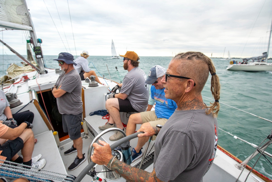 Champion sailor Tim Prophit of St. Clair Shores sits at the helm aboard his boat Fast Tango while nearing the starting line with his crew during a weekly race hosted by Bayview Yacht Club on the Detroit River on Tuesday, June 25, 2024.