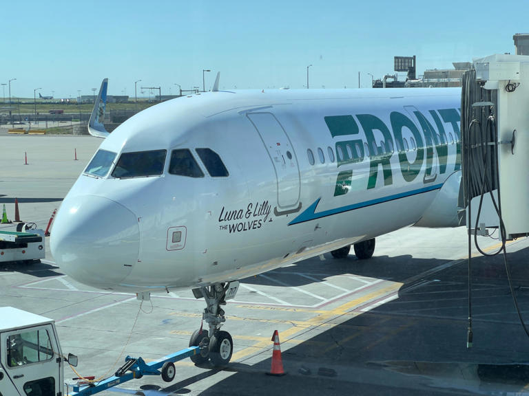 A Frontier Airlines plane sits at the gate at Denver International Airport in Denver, on July 30, 2023. Frontier Airlines is giving away free flights this summer through its "Family Summer Getaway" campaign.