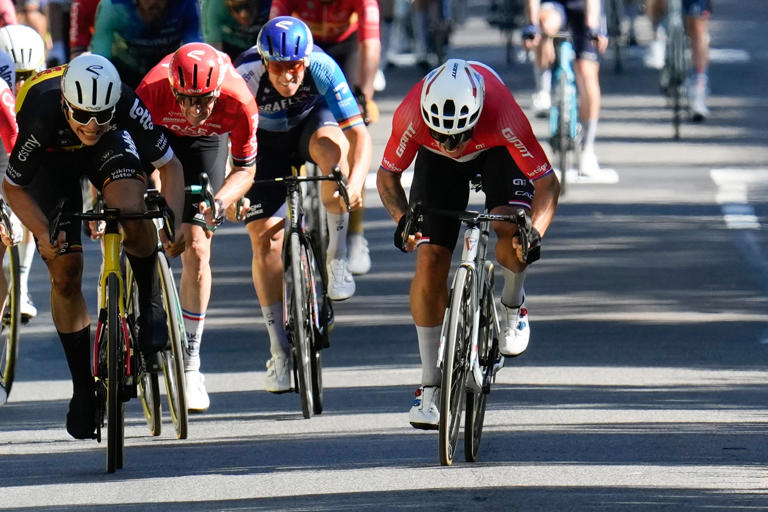 Dylan Groenewegen (right) sprints to the finish line to win Stage 6 of the Tour de France.