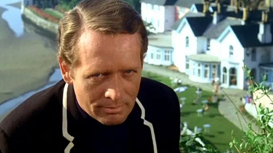 <p>While his name might not ring any bells for younger audiences, McGoohan was the star of The Prisoner, a 1967 television series that aired at the same time as Star Trek: The Original Series. </p><p>The premise of this show is that McGoohan plays a British intelligence officer whose resignation causes his abduction and relocation. </p><p>He wakes up in a strange village on the coast where everyone has numbers instead of names, and he must find a way to escape without getting killed or re-captured by the high-tech enforces who ensure that none of the residents can leave this mysterious village.</p>