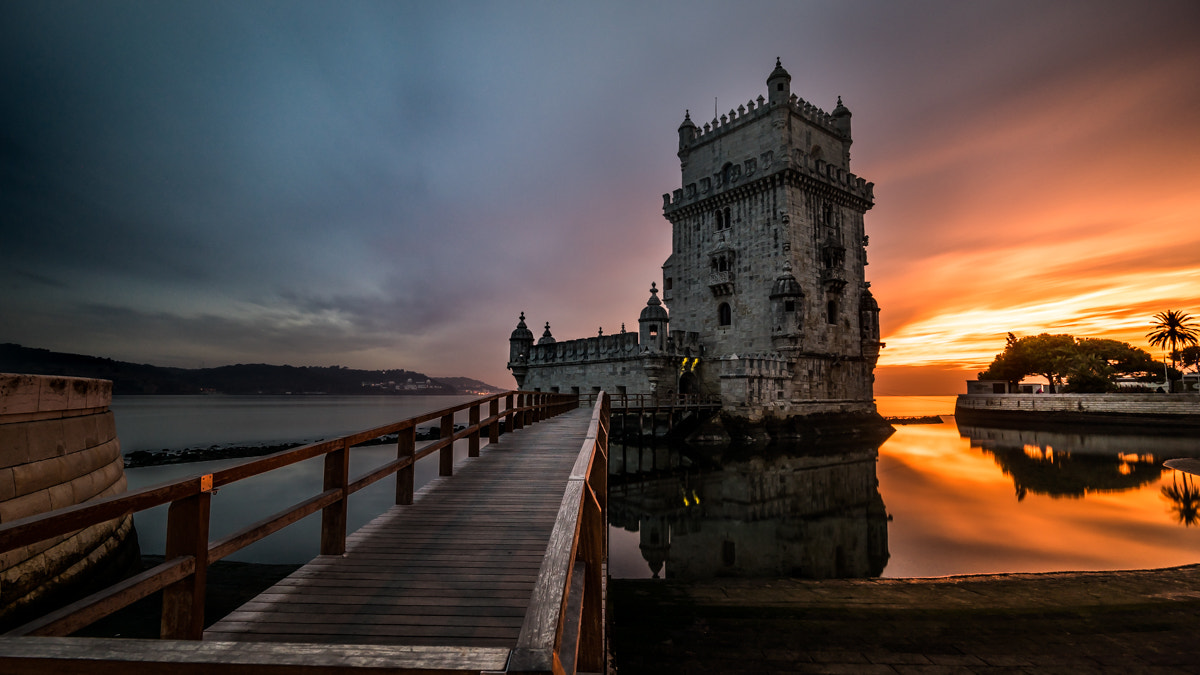 Accessed via a narrow pathway extending into the Tagus River, the <a href="https://en.wikipedia.org/wiki/Bel%C3%A9m_Tower#Interior" rel="noreferrer">Tower of Belém</a> stands as an iconic symbol of Lisbon. Its Manueline architecture, characterized by maritime motifs and intricate carvings, commemorates Portugal's explorations during the Age of Discoveries. It is a striking chalk-white monument reflecting the city's shifting landscape and historical heritage, a cultural beacon, reminding Portuguese citizens and visitors of the nation's glorious past.