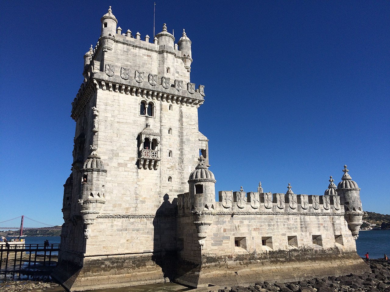 Belém Tower, officially known as the Tower of Saint Vincent (Portuguese: Torre de São Vicente), is a 16th-century fortification located in Lisbon, Portugal. It served as a point of embarkation and disembarkation for Portuguese explorers and as a ceremonial gateway to the city. <br><br>The tower symbolizes Portugal's maritime and colonial power during the early modern period. Built during the height of the Portuguese Renaissance and constructed from lioz limestone, the structure comprises a bastion and a 100-foot, four-story tower.