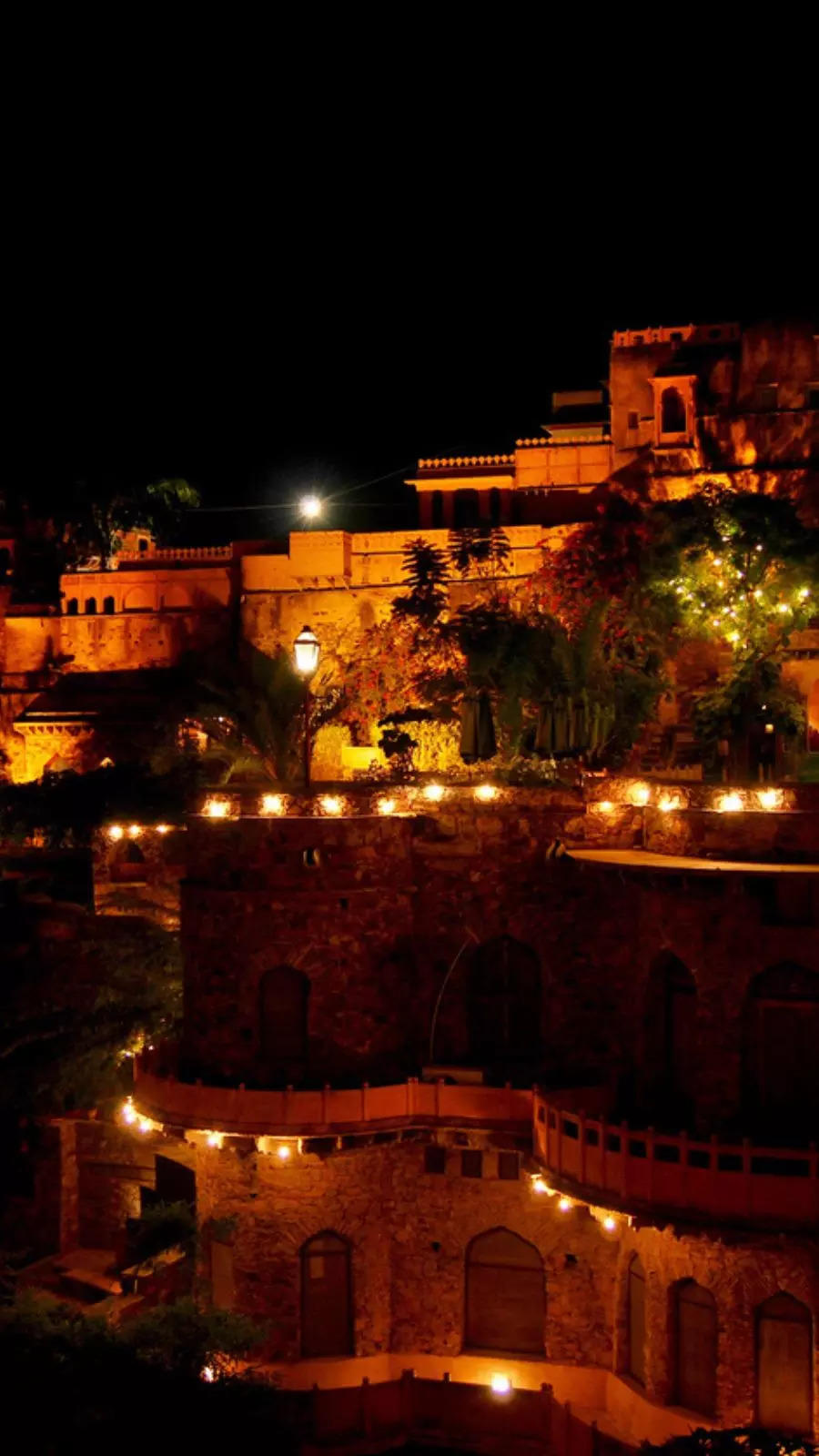 About 122 km from Delhi, Neemrana Fort Palace is a 15th-century heritage hotel offering panoramic views and a glimpse into Rajasthan's royal history.