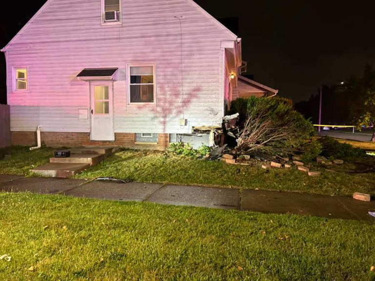 PHOTOS: Car crashes into local home, 2 badly hurt