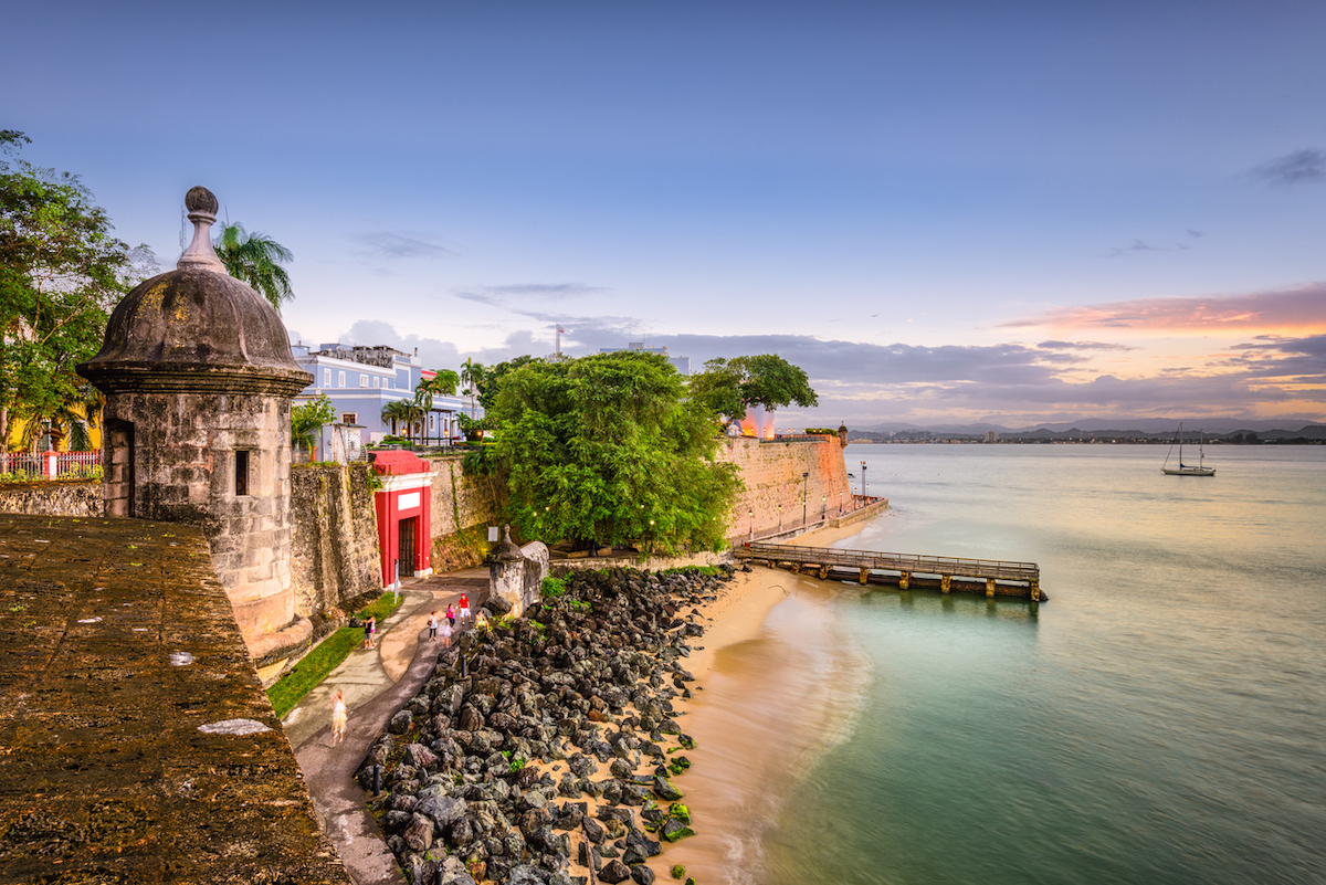 <p>Beloved for its charming cobblestone streets, pastel-hued buildings, high-spirited culture, and scenic natural beauty, Puerto Rico is another top Caribbean destination to visit this year.</p><p>"Puerto Rico offers a blend of Caribbean culture and American convenience (no passport needed), with highlights including Old San Juan's colonial charm and the <a rel="noopener noreferrer external nofollow" href="https://vieques.com/island-bioluminescent-bay/">bioluminescent bay</a> in Vieques," says Bang. Its vibrant culture blends Taino, African, and Spanish influences—all of which are evident in local music, dance, and cuisine, she adds.</p><p>If you choose Puerto Rico for your vacation, Bang recommends leaving plenty of time to tour the island's historic sites in San Juan's historic Old Town, especially significant forts like <a rel="noopener noreferrer external nofollow" href="https://www.nps.gov/saju/learn/historyculture/el-morro.htm">El Morro</a> and <a rel="noopener noreferrer external nofollow" href="https://www.discoverpuertorico.com/profile/la-fortaleza/8013">La Fortaleza</a>.<strong>Maya Kapoor-Miller</strong>, travel manager at <a rel="noopener noreferrer external nofollow" href="https://www.dreamport.me/">Dreamport</a>, says that Puerto Rico is her top recommendation in the Caribbean for 2024: "From bathing in natural pools beneath waterfalls to taking in the gorgeous scenery from its many hiking trails, there is something to enjoy for travelers of all tastes and ages."</p><p>"If being in nature is something you enjoy the most, head towards <a rel="noopener noreferrer external nofollow" href="https://www.fs.usda.gov/elyunque/">El Yunque National Forest</a>, the only tropical forest in the U.S. National Forest System," Kapoor-Miller recommends.</p><p>For an unparalleled luxury stay, nestle into the secluded <a rel="noopener noreferrer external nofollow" href="https://www.ritzcarlton.com/en/hotels/sjudo-dorado-beach-a-ritz-carlton-reserve/overview/">Dorado Beach, A Ritz-Carlton Reserve</a>. Or, for a more local experience, check out one of the many boutique hotels in Old San Juan.<p><strong>RELATED: <a rel="noopener noreferrer" href="https://bestlifeonline.com/best-road-trips-for-beach-lovers/">6 Best U.S. Road Trips for Beach Lovers</a>.</strong></p></p>
