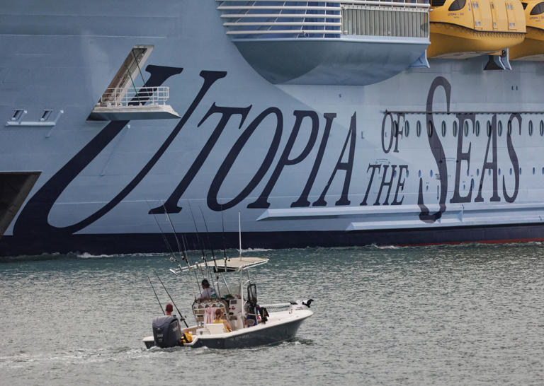 Fishermen watch the Royal Caribbean Utopia of the Seas make its inaugural arrival at Port Canaveral on Thursday, July 11, 2024.