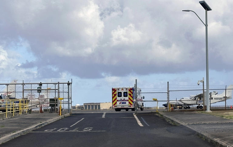 FILE - An ambulance enters Lihue Airport on the island of Kauai, Hawaii on Friday, July 12, 2024. Authorities suspended the search for a tour helicopter pilot and one of his passengers after they crashed into the ocean off the Hawaiian island of Kauai last week. (Chris Jensen via AP, File)