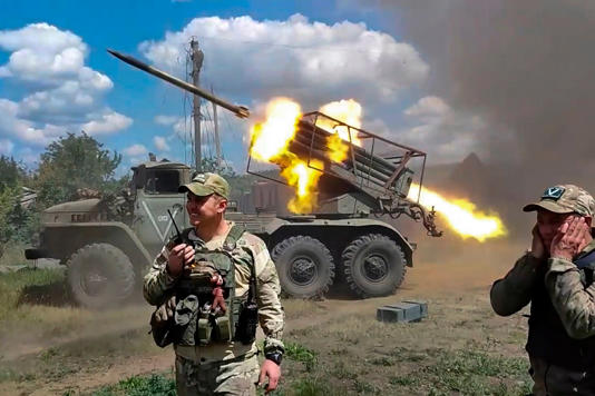 Russian soldiers fire from the BM-21 ‘Grad’ self-propelled 122mm multiple rocket launcher in an undisclosed location in Ukraine (Picture: AP)