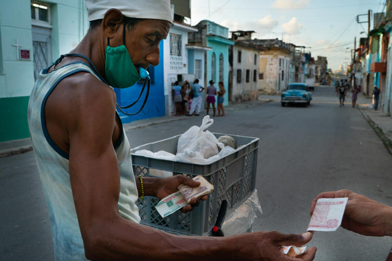 A vendor sells bread in Havana in 2022 as the country endured an economic crisis brought on by many factors, including Trump-era sanctions that continued under President Biden.